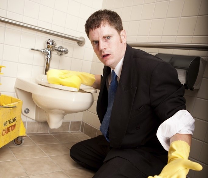 Unexpected restroom cleaning situation with a surprised office worker